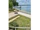 Inviting backyard with sandy beach, tiki umbrella, and a private dock on a serene lake at 1050 E Eagle Ave, Eagle Lake, FL 33839