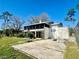 Home featuring a spacious backyard with a basketball court and screened-in porch at 1050 E Eagle Ave, Eagle Lake, FL 33839