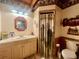 Cozy bathroom features a vanity with a sink, framed mirror, toilet, and themed wallpaper and shower curtain at 1050 E Eagle Ave, Eagle Lake, FL 33839