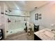 Beautiful updated bathroom with a tile shower featuring a glass door, rainfall shower head, and modern fixtures at 1050 E Eagle Ave, Eagle Lake, FL 33839