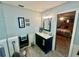 Bathroom featuring a vanity with a marble countertop, and access to the main bedroom at 1050 E Eagle Ave, Eagle Lake, FL 33839
