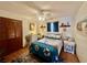 Bedroom featuring a ceiling fan, wood floors, and nautical-themed decor at 1050 E Eagle Ave, Eagle Lake, FL 33839