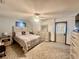 Bright bedroom with light wood furniture, neutral carpet, and ceiling fan at 1050 E Eagle Ave, Eagle Lake, FL 33839