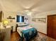 Bedroom featuring a ceiling fan, wood floors, and nautical-themed decor at 1050 E Eagle Ave, Eagle Lake, FL 33839