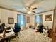 Bedroom with an office featuring a ceiling fan, carpet floors, and natural light at 1050 E Eagle Ave, Eagle Lake, FL 33839