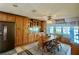 Dining area with wood table and seating next to built-in cabinets and window at 1050 E Eagle Ave, Eagle Lake, FL 33839