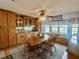 Dining area with wood table and seating next to built-in cabinets and window at 1050 E Eagle Ave, Eagle Lake, FL 33839