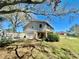 Two-story home showcasing a ground-level garage, screened-in porch, and stone accents at 1050 E Eagle Ave, Eagle Lake, FL 33839