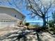 Stunning waterfront home with a gray exterior, stone accents, and lush landscaping at 1050 E Eagle Ave, Eagle Lake, FL 33839