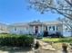 Charming single-story home with a welcoming front porch and well-maintained landscaping at 1050 E Eagle Ave, Eagle Lake, FL 33839