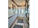 Inviting hallway featuring tiled floors, framed art, and a front door with decorative glass at 1050 E Eagle Ave, Eagle Lake, FL 33839