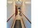 Hallway with tile flooring and baseboard trim leading to bathroom at 1050 E Eagle Ave, Eagle Lake, FL 33839