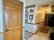 Hallway with tiled floor, wood accents, and decorative patriotic wall art at 1050 E Eagle Ave, Eagle Lake, FL 33839