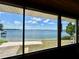 Expansive lake view through screened windows, offering picturesque scenery from indoors at 1050 E Eagle Ave, Eagle Lake, FL 33839
