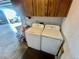 Laundry room with white washer and dryer units, utility sink, and storage cabinets at 1050 E Eagle Ave, Eagle Lake, FL 33839