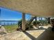 Covered patio space with stairs leading to the yard and beautiful water views at 1050 E Eagle Ave, Eagle Lake, FL 33839