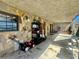 Large, covered patio with stone accents, ideal for storage and accessing the outdoors at 1050 E Eagle Ave, Eagle Lake, FL 33839