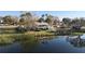 Waterfront home's rear exterior boasts a screened-in porch and spacious yard at 1050 E Eagle Ave, Eagle Lake, FL 33839