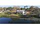 Rear exterior of the home with a screened porch and ample yard space by the water at 1050 E Eagle Ave, Eagle Lake, FL 33839