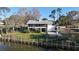 Back of a waterfront home with a screened-in porch and a partial basketball court at 1050 E Eagle Ave, Eagle Lake, FL 33839
