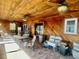 Sunroom with wood ceilings, tile flooring, and an array of furniture at 1050 E Eagle Ave, Eagle Lake, FL 33839