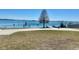 Picturesque water access featuring a peaceful lake view, grassy area and signage at 1050 E Eagle Ave, Eagle Lake, FL 33839