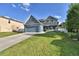 Charming two-story home with a well-manicured lawn and beautiful blue exterior paint at 1072 Bethpage Rd, Auburndale, FL 33823