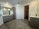 Spacious primary bathroom with dual vanities, modern fixtures, and a walk-in closet at 1205 Lake Loop Rd, Winter Haven, FL 33880