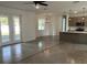 Bright living room area featuring sleek flooring, gray walls, modern lighting, and a view into the adjacent kitchen at 1205 Lake Loop Rd, Winter Haven, FL 33880