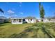 Spacious backyard featuring a well-maintained lawn and an enclosed patio area at 1229 Rawls Dr, Lakeland, FL 33801