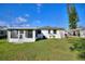 Large backyard with a screened-in porch, perfect for outdoor relaxation and entertainment at 1229 Rawls Dr, Lakeland, FL 33801