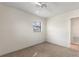 Neutral bedroom with carpet and walls, fan and light fixture and a single window at 1229 Rawls Dr, Lakeland, FL 33801