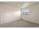 This bedroom features neutral carpet, fresh white walls, and an overhead ceiling fan and light at 1229 Rawls Dr, Lakeland, FL 33801