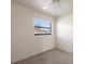 Bright bedroom featuring neutral walls, carpet flooring, and a window offering views of the outdoors at 1229 Rawls Dr, Lakeland, FL 33801