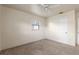 Simple bedroom with neutral carpet and walls featuring a ceiling fan and a single window at 1229 Rawls Dr, Lakeland, FL 33801