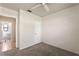 This bedroom features neutral carpet, fresh white walls, and an overhead ceiling fan at 1229 Rawls Dr, Lakeland, FL 33801