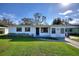 Charming single-story home featuring a well-maintained lawn, tidy landscaping, and a welcoming entryway at 1229 Rawls Dr, Lakeland, FL 33801