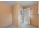 Hallway with textured walls and white doors, offering access to additional rooms and storage at 1229 Rawls Dr, Lakeland, FL 33801