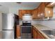 Updated kitchen with stainless steel appliances, granite countertops and tile backsplash at 1229 Rawls Dr, Lakeland, FL 33801