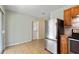 Well-lit kitchen features stainless steel refrigerator and access to back door at 1229 Rawls Dr, Lakeland, FL 33801