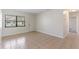 Bright living room features neutral paint, tile floors, and a window with natural light at 1229 Rawls Dr, Lakeland, FL 33801