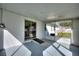 Enclosed patio featuring light walls, sliding glass door, and screened openings to the backyard at 1229 Rawls Dr, Lakeland, FL 33801