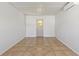 This bonus room features white walls and tiled floors at 1229 Rawls Dr, Lakeland, FL 33801