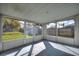 Enclosed sunroom featuring large sliding windows providing ample natural light and backyard views at 1229 Rawls Dr, Lakeland, FL 33801