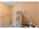 Utility room featuring water heater, plumbing, and standard tan painted walls at 1229 Rawls Dr, Lakeland, FL 33801