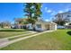 Charming single-story home with a covered parking, manicured lawn, and inviting curb appeal at 1233 Rawls Dr, Lakeland, FL 33801