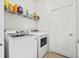 Bright laundry room with new washer and dryer, and wire shelf at 126 Seneca Ln, Davenport, FL 33897