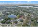 A home outlined in red sits near a tranquil pond in a neighborhood of trees at 128 Lake Ring Dr, Winter Haven, FL 33884