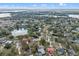Tranquil neighborhood view with a home outlined in red next to a peaceful pond and wooded surroundings at 128 Lake Ring Dr, Winter Haven, FL 33884