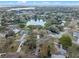 Aerial shot overlooking neighborhood near lakefront property and lush greenery at 128 Lake Ring Dr, Winter Haven, FL 33884